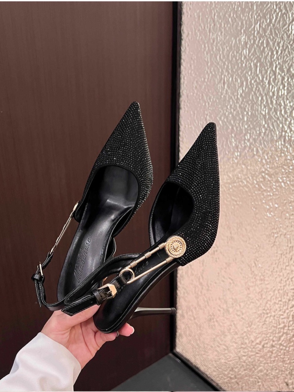 A Classy ChicBlack Rhinestone Pointed Slingback Pumps with Gold Accent.